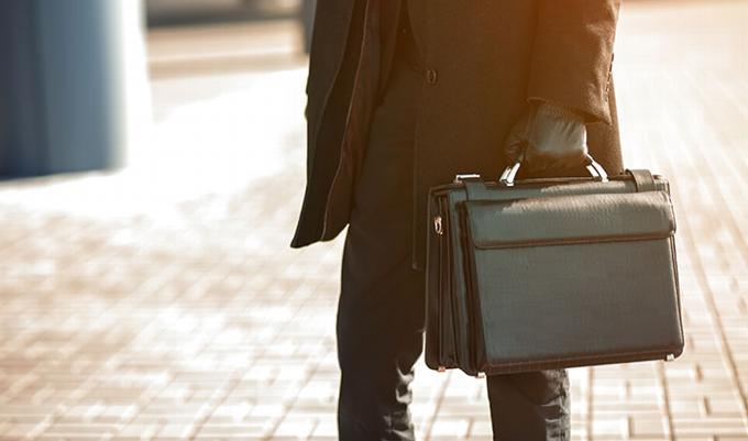 man holding briefcase in street